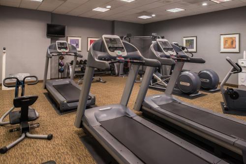 a gym with several tread machines in a room at Holiday Inn Ontario Airport - California, an IHG Hotel in Ontario