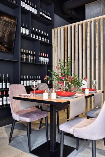 a dining room with a table and some wine bottles at Hotel Arche Geologiczna in Warsaw