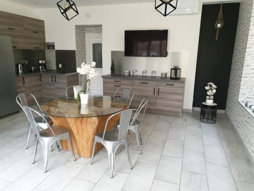 a dining room with a wooden table and chairs at Equi-lodges in Fraisnes-en-Saintois