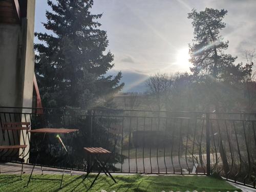 a balcony with a table and a fence with the sun at Agroturystyka Lucyna Babińska in Wünschelburg