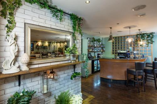 a bar in a restaurant with plants on the wall at Hotel Penzance in Penzance