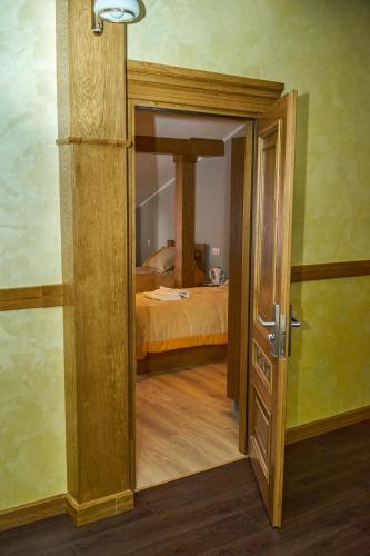 an open door to a bedroom with a bed at Східний in Brzezhany