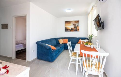 een woonkamer met een blauwe bank en een tafel bij Apartments Dora in Vantačići