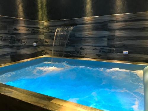 a hot tub with a waterfall in a room at Villitaly suite & coffee Salerno in Baronissi