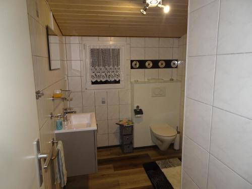 a small bathroom with a sink and a toilet at Fab Studio in Granges