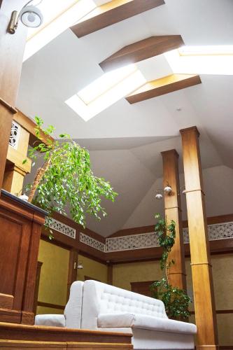 a living room with a white couch and a ceiling at Східний in Brzezhany