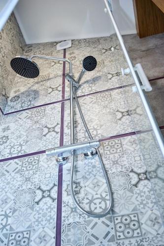 a shower in a bathroom with a tile floor at Східний in Brzezhany