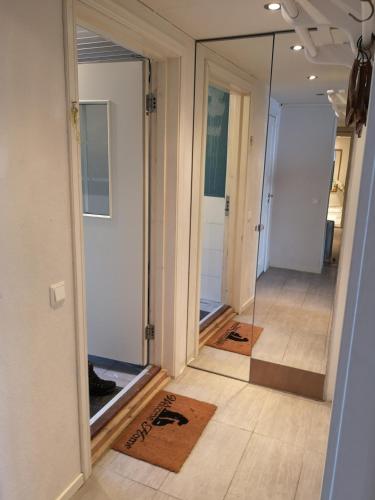 a room with a mirror and a hallway with a door at Malvik, Hundhamaren, Trondheim in Malvik