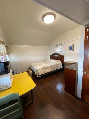 a bedroom with a bed and a table in a room at The Cottages at Harvey Lake in Northwood