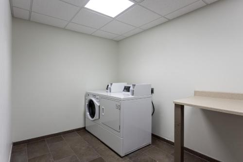 a laundry room with a washer and dryer at Holiday Inn San Marcos Convention Center by IHG in San Marcos