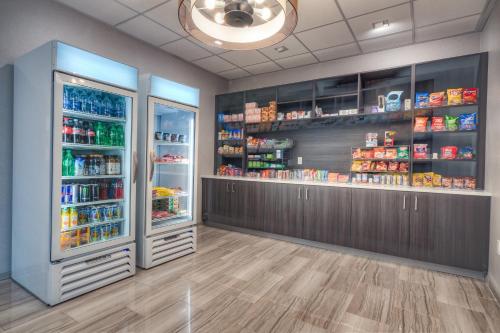 a store with two refrigerators in a room at Holiday Inn Tacoma Mall by IHG in Tacoma