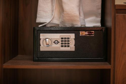 a microwave oven sitting on a wooden shelf at Viryla Boutique Hotel in Vientiane