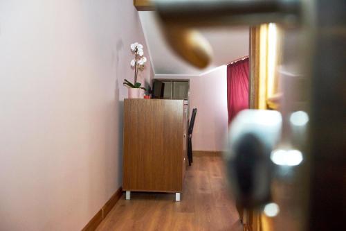 a room with a wooden cabinet with flowers on it at Східний in Brzezhany