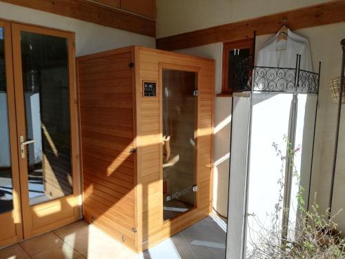 a wooden room with a sauna in a house at La Maison Bleue23 in Sardent