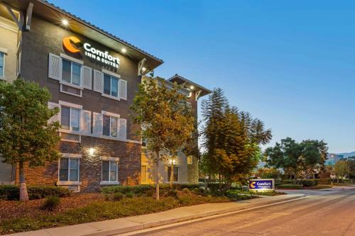 a building with a sign on the side of it at Comfort Inn & Suites Near Ontario Airport in Ontario