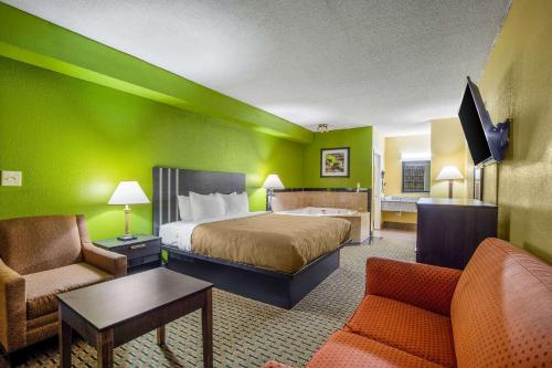 a hotel room with a bed and a couch at Quality Inn West Columbia - Cayce in West Columbia