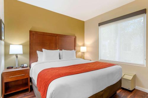 a bedroom with a large bed and a window at Comfort Inn & Suites Near Ontario Airport in Ontario