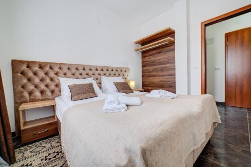 a bedroom with two beds with towels on them at Zlatibor Hills 31 in Zlatibor