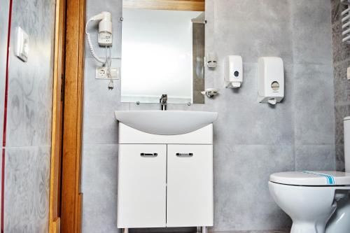 a bathroom with a sink and a toilet at Східний in Brzezhany