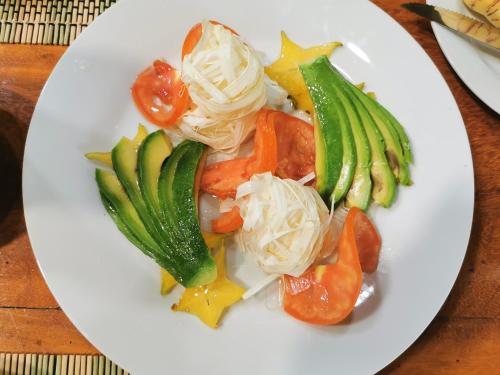 a white plate of food with vegetables on a table at Grand Amazon Lodge and Tours - All Inclusive in Paraíso