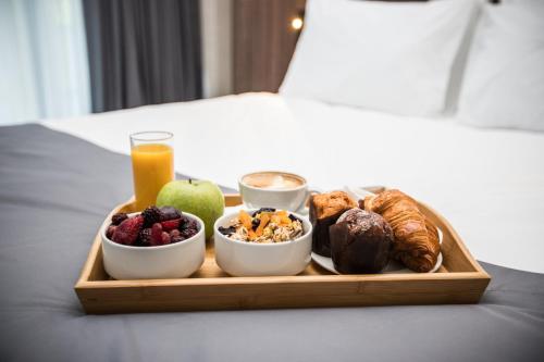 a tray of breakfast food on a bed at Holiday Inn Telavi by IHG in Tʼelavi
