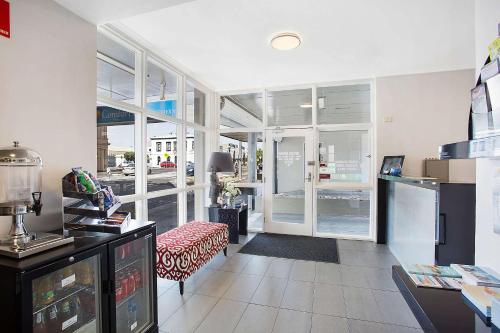a living room with a couch and some windows at Comfort Inn Western in Warrnambool