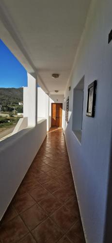 a hallway of a house with white walls and a tile floor at Appartement Miradorgolf in Cabo Negro