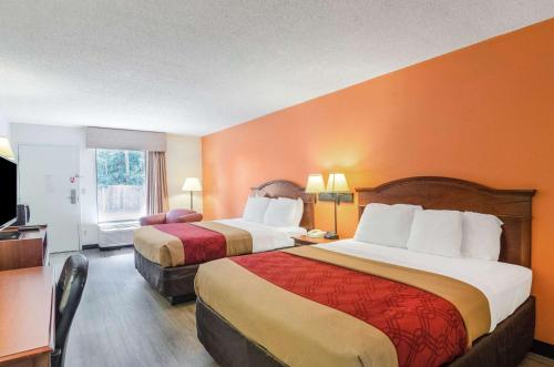 um quarto de hotel com duas camas e uma televisão em Econo Lodge Inn & Suites em Gulfport