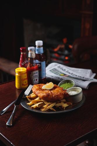 a plate of food with chicken and french fries on a table at The Mayson in Dublin