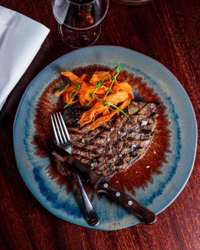 a blue plate with food on a wooden table at The Mayson in Dublin