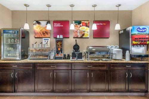 a restaurantacist with a counter with food on it at Comfort Suites Elkhart South in Elkhart