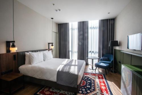 a hotel room with a bed and a television at Holiday Inn Telavi by IHG in Tʼelavi