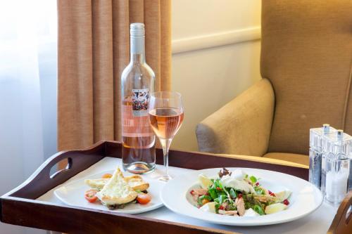 a tray with a bottle of wine and a plate of food at Holiday Inn Taunton M5, Jct25 by IHG in Taunton