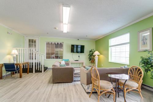 a living room with green walls and a couch and a table at Marylander Condominiums, 90 steps from the beach in Ocean City