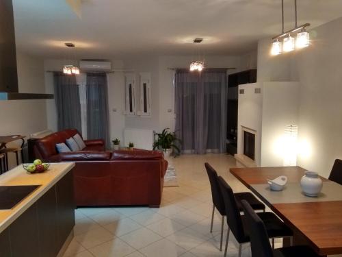 a living room with a couch and a table at CK Lake View in Kastoria