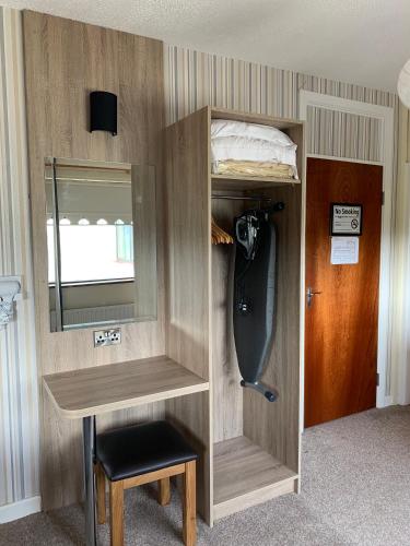 a room with a bunk bed and a desk and a mirror at Station House Bed & Breakfast in Ennistymon