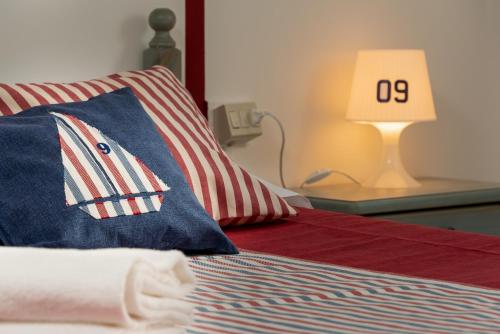 a bed with a pillow with the number on it at Le Palme Di Conturrana in San Vito lo Capo