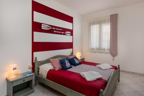 a bedroom with a bed and a lamp at Le Palme Di Conturrana in San Vito lo Capo