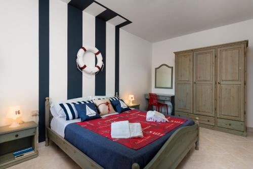 a bedroom with a bed with a soccer ball on the wall at Le Palme Di Conturrana in San Vito lo Capo