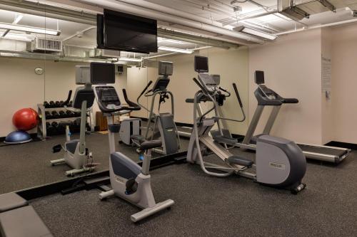 a gym with several exercise machines and a flat screen tv at Holiday Inn Express & Suites San Diego - Mission Valley by IHG in San Diego