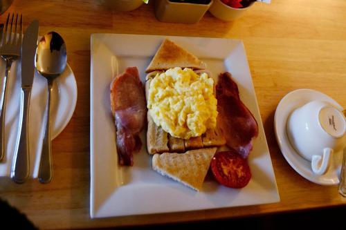 a plate of breakfast food with eggs bacon and toast at Station House Bed & Breakfast in Ennistymon