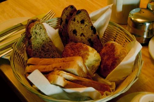 a basket filled with different types of bread on a table at Station House Bed & Breakfast in Ennistymon