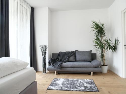 a living room with a couch and a rug at Apartments Sabine K in Merano