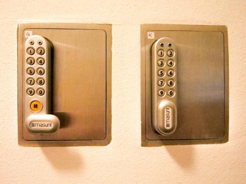 two remote controls are attached to a wall at Apartments Sabine K in Merano