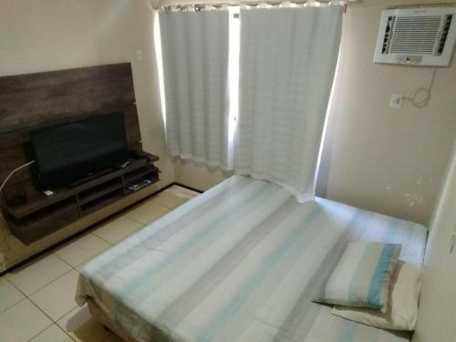 Un pat sau paturi într-o cameră la Silva Hospedagem