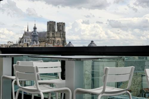 a dining room with a balcony overlooking a city at Holiday Inn Reims Centre, an IHG Hotel in Reims