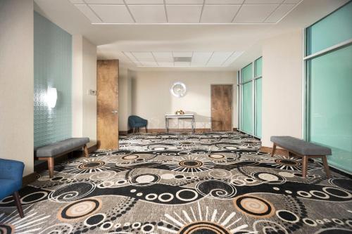 a room with a large carpet on the floor with two chairs at Fort Pontchartrain Detroit, a Wyndham Hotel in Detroit