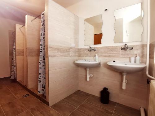 a bathroom with two sinks and a mirror at DIAMOND house in Brezno