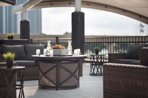 a table with a bowl of fruit on a patio at Fort Pontchartrain Detroit, a Wyndham Hotel in Detroit