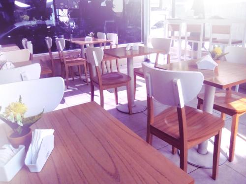 a group of tables and chairs in a restaurant at Hotel Juramento in Buenos Aires